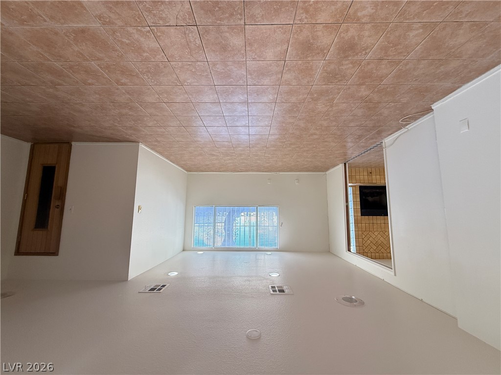 7227 Limestone Road Las Vegas, NV 89147 - Photo 12 of 31 A spacious family room offers ample natural light and a classic tile ceiling.