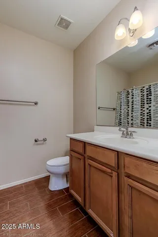 a bathroom with a sink a toilet and a mirror
