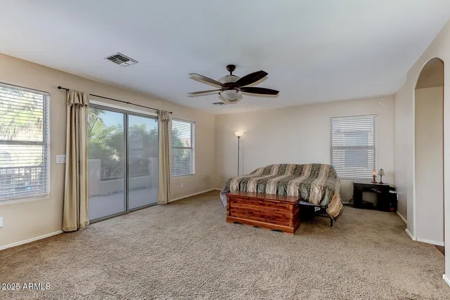 a bedroom with a bed and a chair