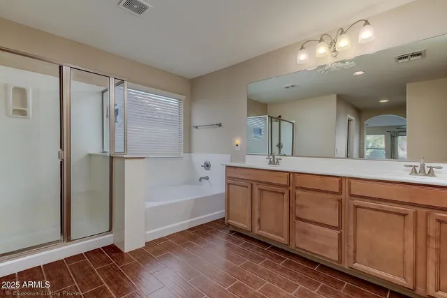 an empty room with wooden floor and closet area