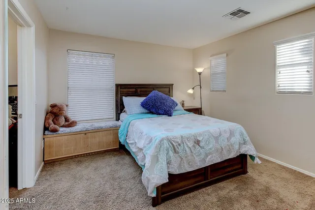 a spacious bathroom with a double vanity sink and a mirror