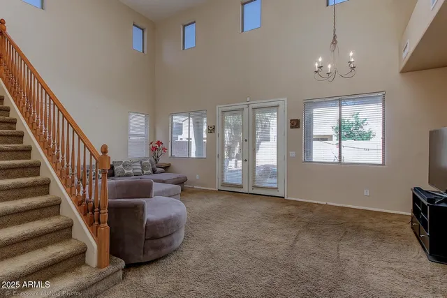a view of a livingroom with furniture staircase and a ceiling fan