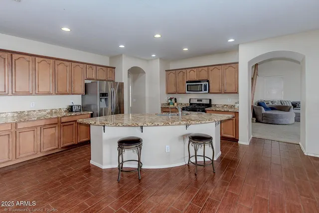 a kitchen with a sink cabinets and wooden floor