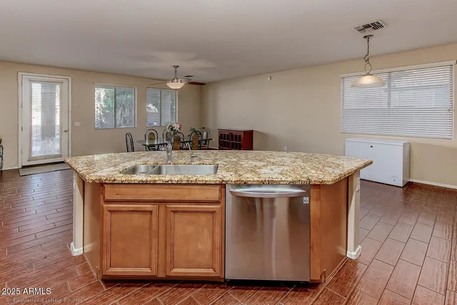 a kitchen with granite countertop a sink and cabinets