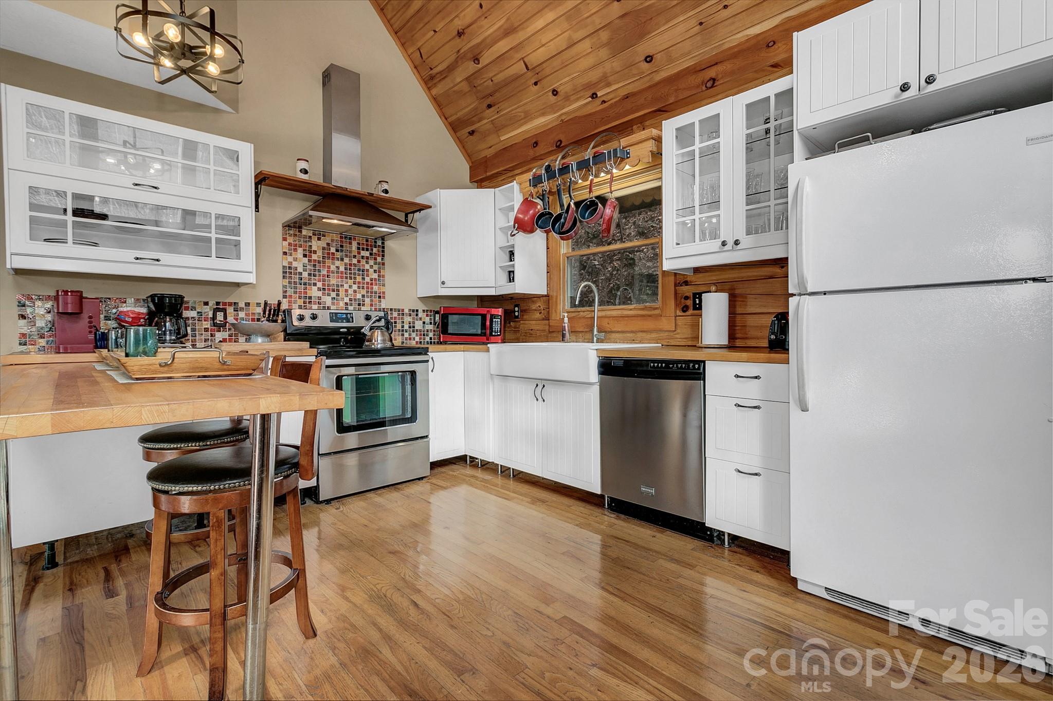 135 Pretty Ridge Maggie Valley, NC 28751 - Photo 20 of 46 a kitchen with stainless steel appliances granite countertop a sink cabinets and wooden floor