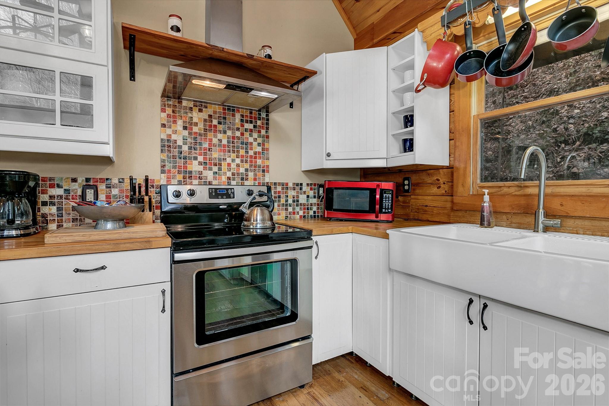 135 Pretty Ridge Maggie Valley, NC 28751 - Photo 22 of 46 a kitchen with stainless steel appliances granite countertop a stove and a sink