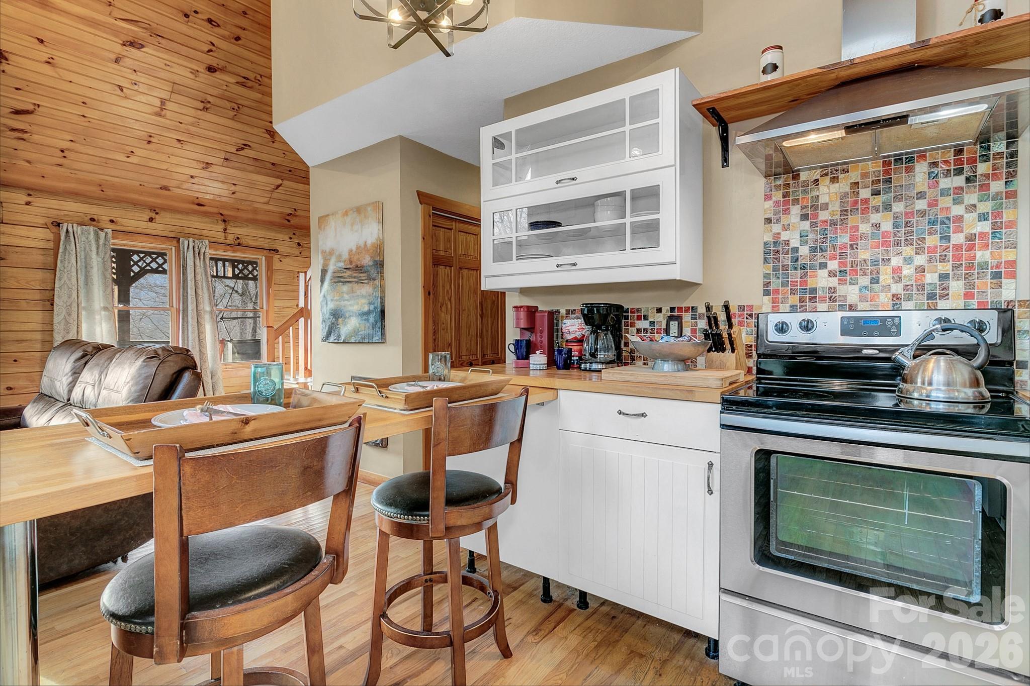 135 Pretty Ridge Maggie Valley, NC 28751 - Photo 24 of 46 a kitchen with a stove a sink and cabinets