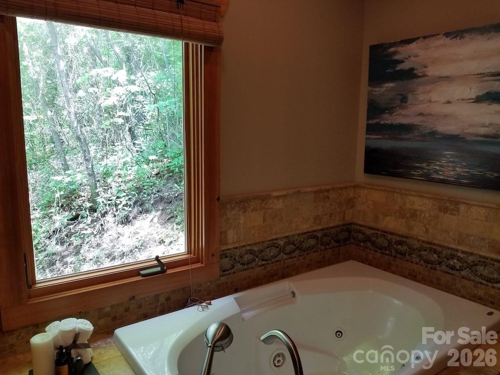 135 Pretty Ridge Maggie Valley, NC 28751 - Photo 29 of 46 a bath tub sitting in a bathroom next to a window