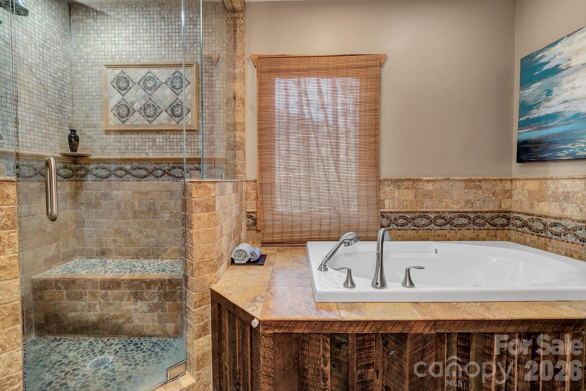 135 Pretty Ridge Maggie Valley, NC 28751 - Photo 32 of 46 a bathroom with a tub sink and mirror