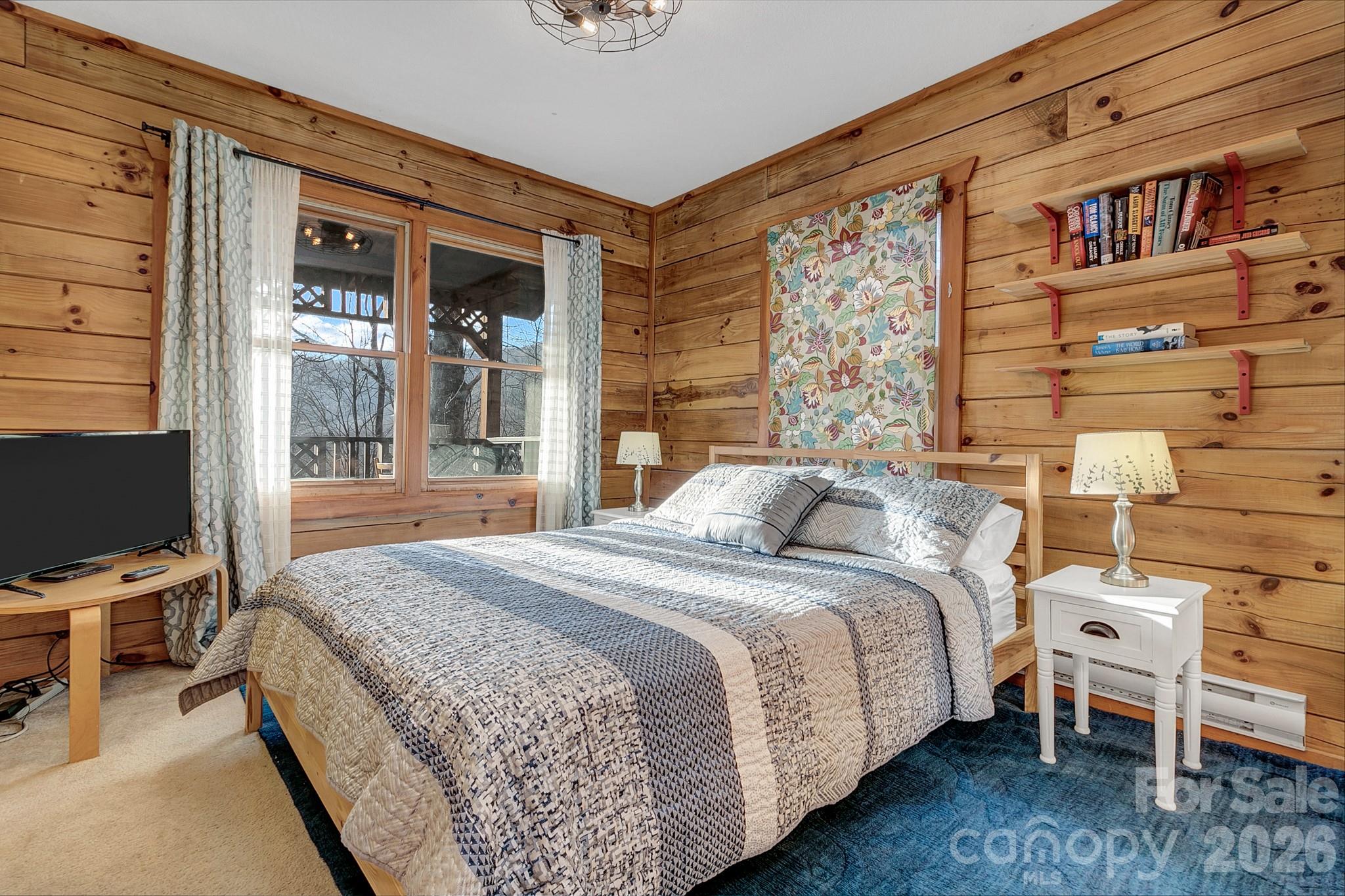 135 Pretty Ridge Maggie Valley, NC 28751 - Photo 33 of 46 a bedroom with a bed wooden floor and lamp