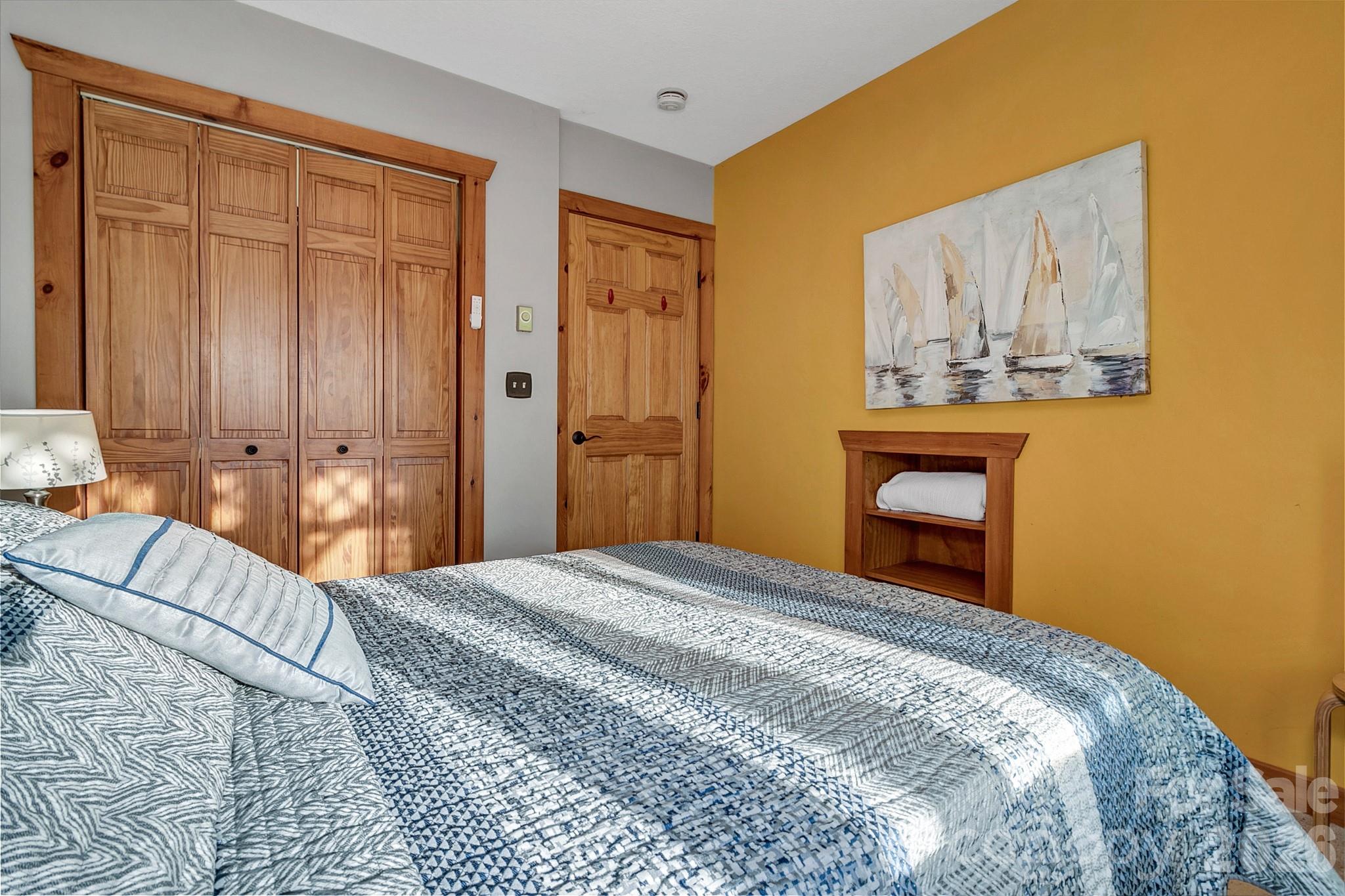 135 Pretty Ridge Maggie Valley, NC 28751 - Photo 34 of 46 a bedroom with a large bed and a painting on the wall