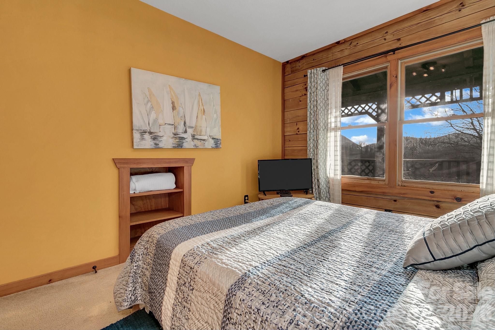 135 Pretty Ridge Maggie Valley, NC 28751 - Photo 36 of 46 a bedroom with a bed and window