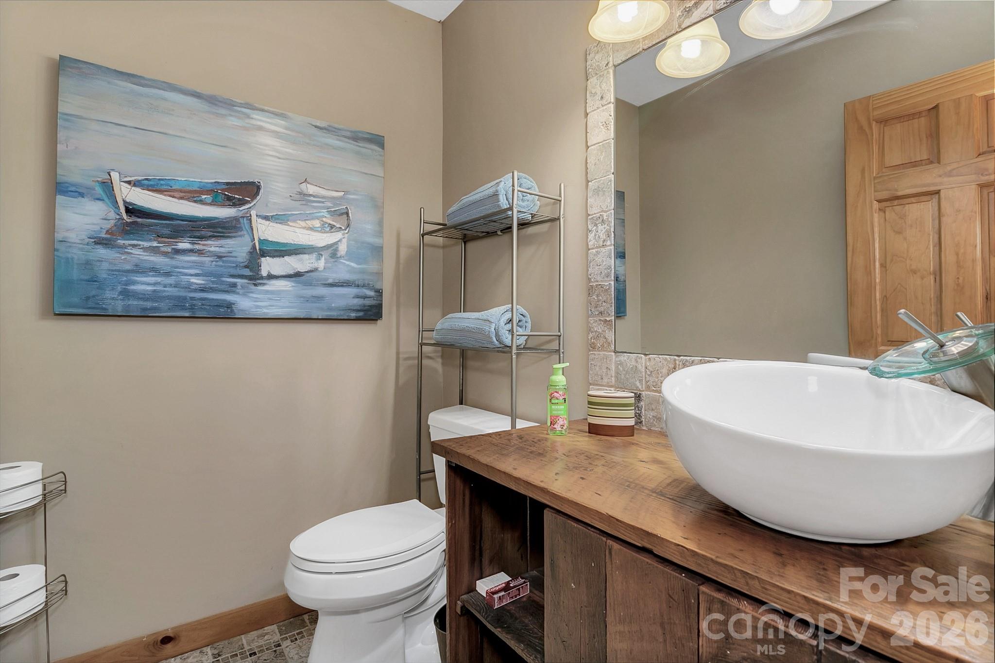 135 Pretty Ridge Maggie Valley, NC 28751 - Photo 38 of 46 a bathroom with a granite countertop toilet and a sink