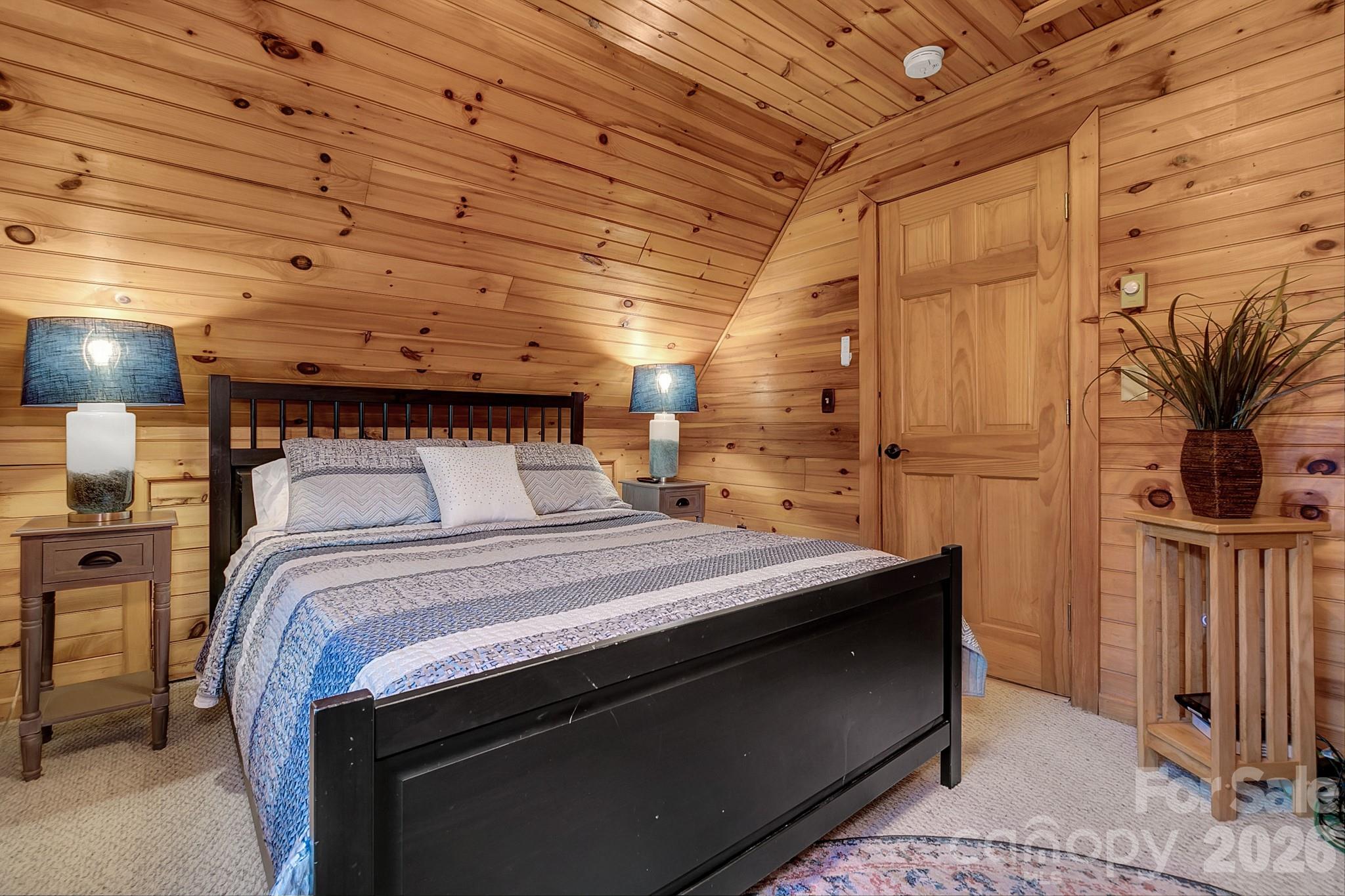 135 Pretty Ridge Maggie Valley, NC 28751 - Photo 41 of 46 a bedroom with a bed and a mirror