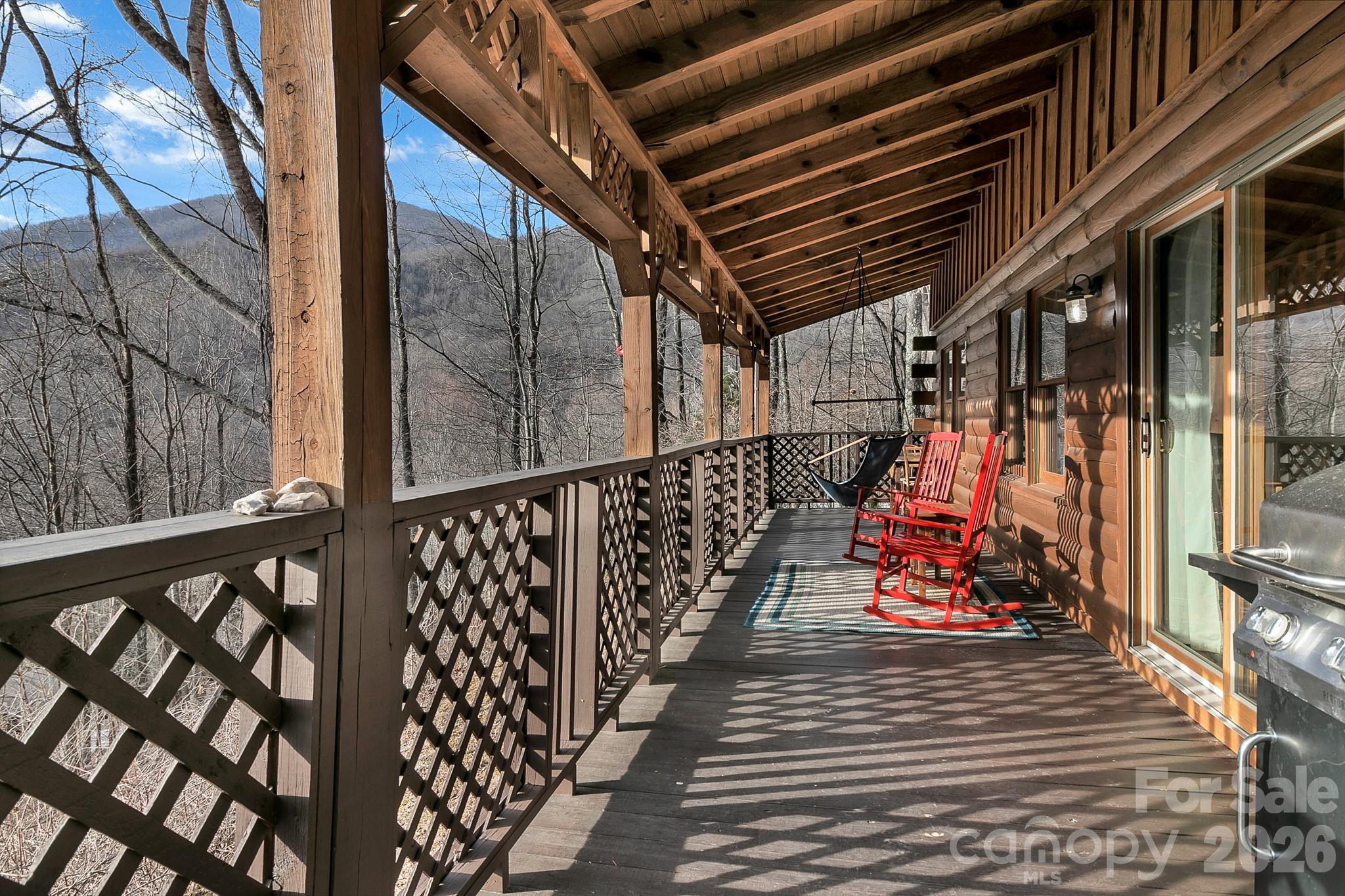 135 Pretty Ridge Maggie Valley, NC 28751 - Photo 6 of 46 a view of a balcony with wooden benches