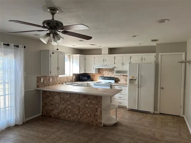 a kitchen with kitchen island a sink stainless steel appliances and cabinets