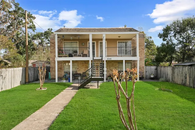 a view of a house with a yard and sitting area
