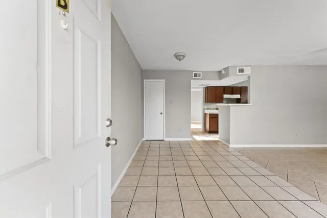 a view of a hallway with wooden cabinet and a fireplace