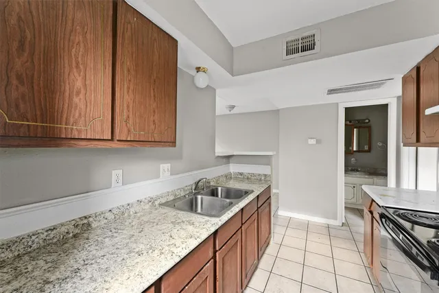 a kitchen that has a sink and a stove