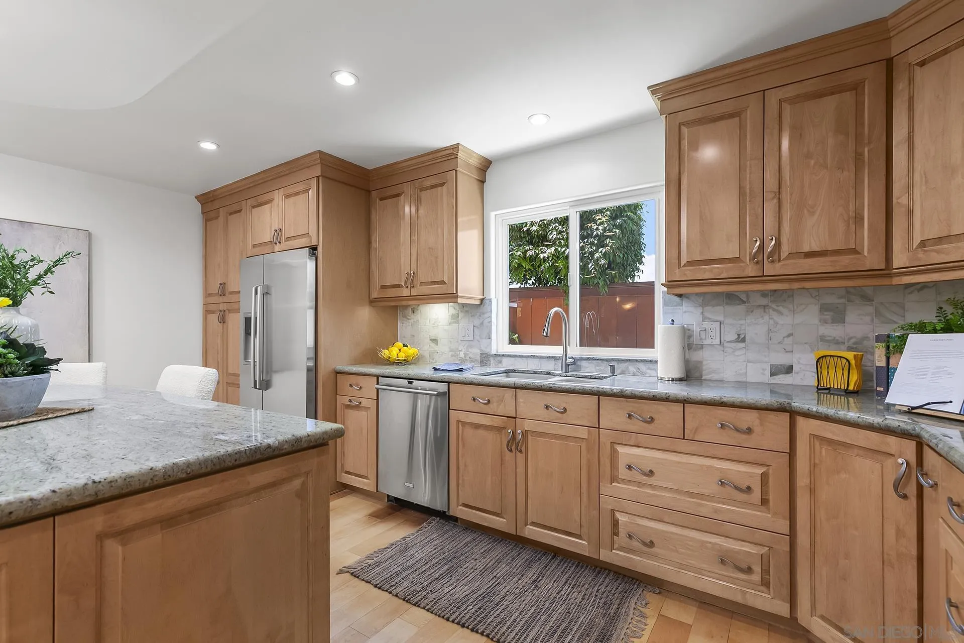 10371 Strathmore Drive Santee, CA 92071 - Photo 20 of 58 a kitchen with granite countertop cabinets stainless steel appliances a sink and a window