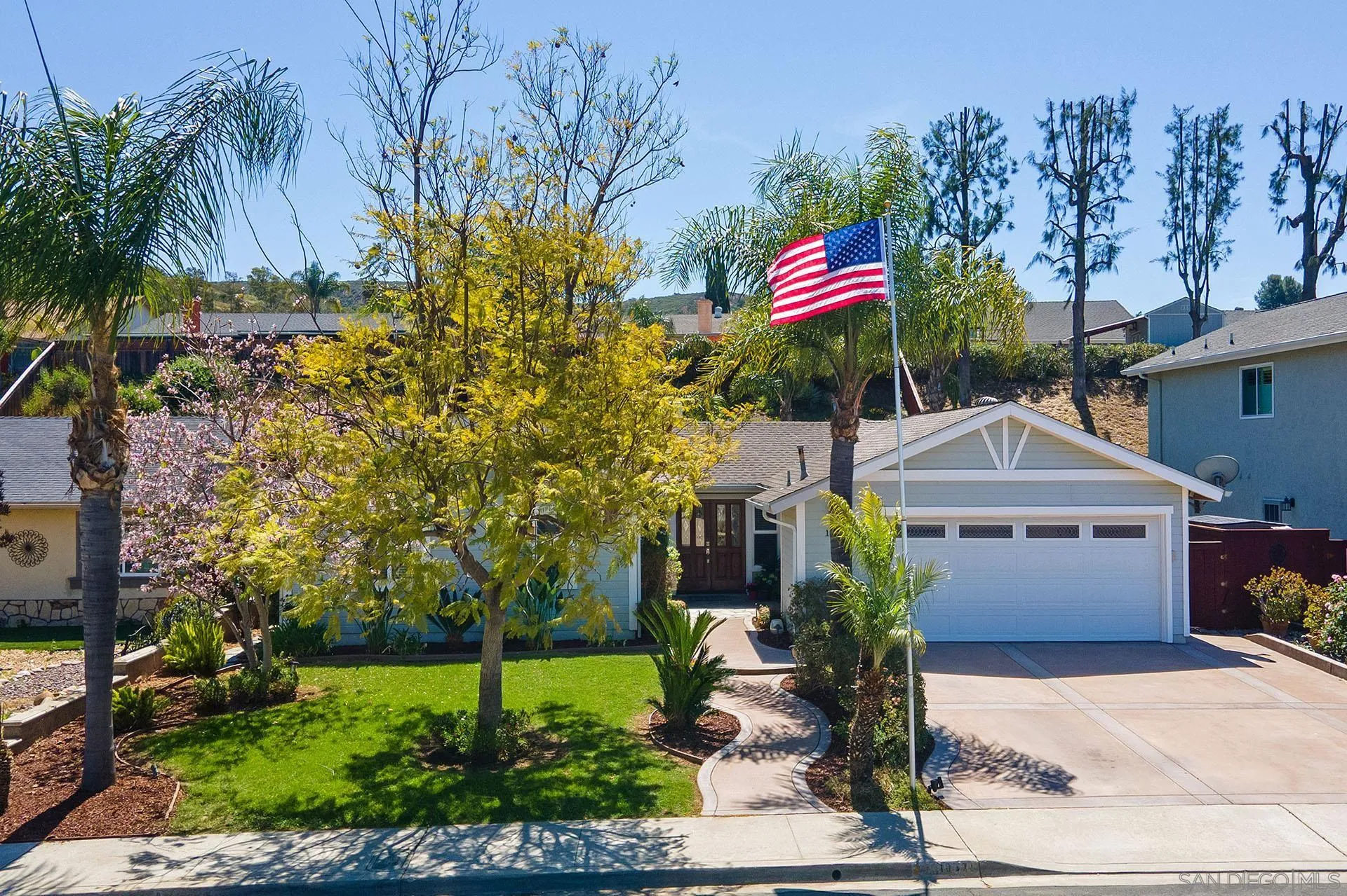 10371 Strathmore Drive Santee, CA 92071 - Photo 2 of 58 a front view of a house with a garden