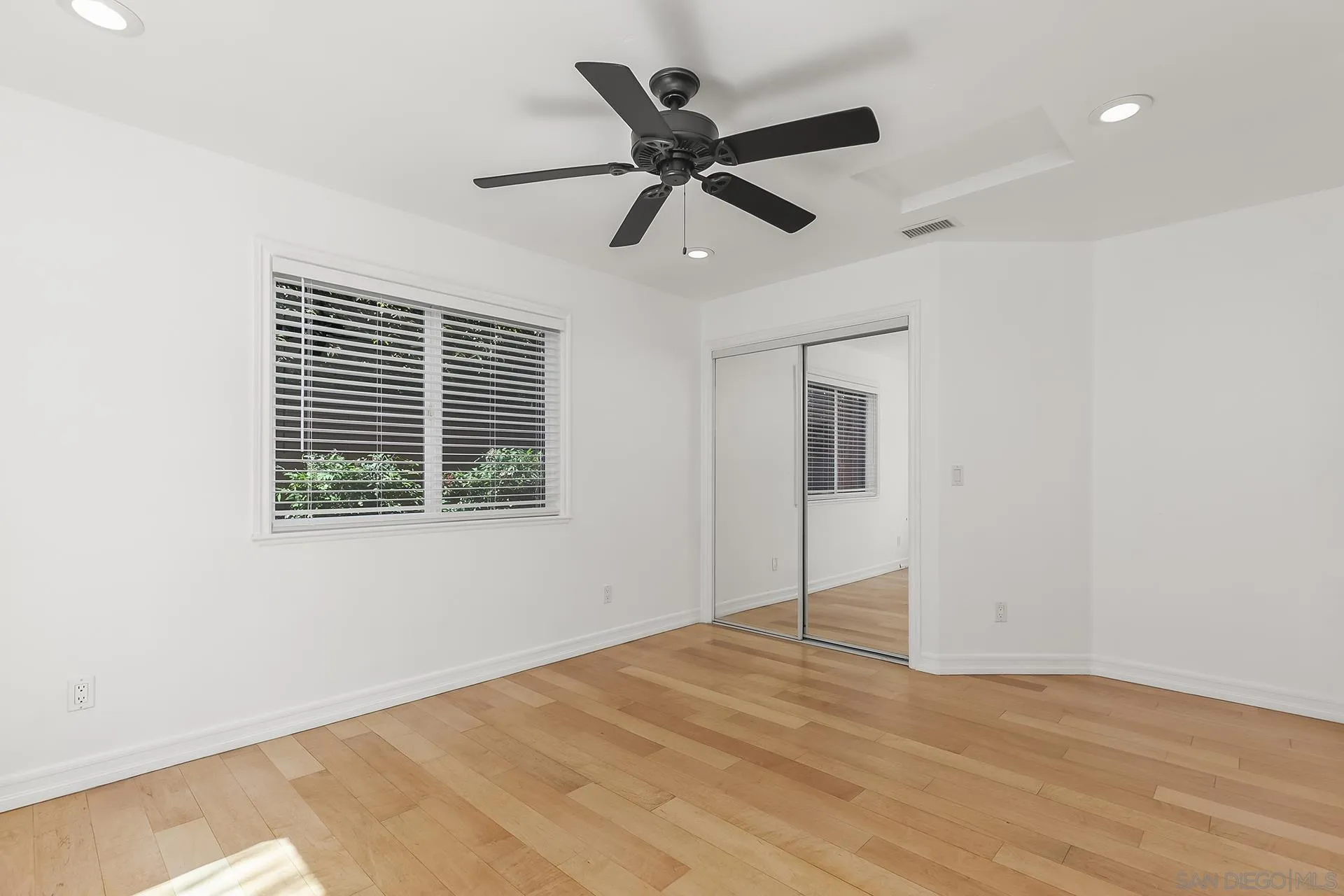 10371 Strathmore Drive Santee, CA 92071 - Photo 32 of 58 a view of an empty room with wooden floor and a window