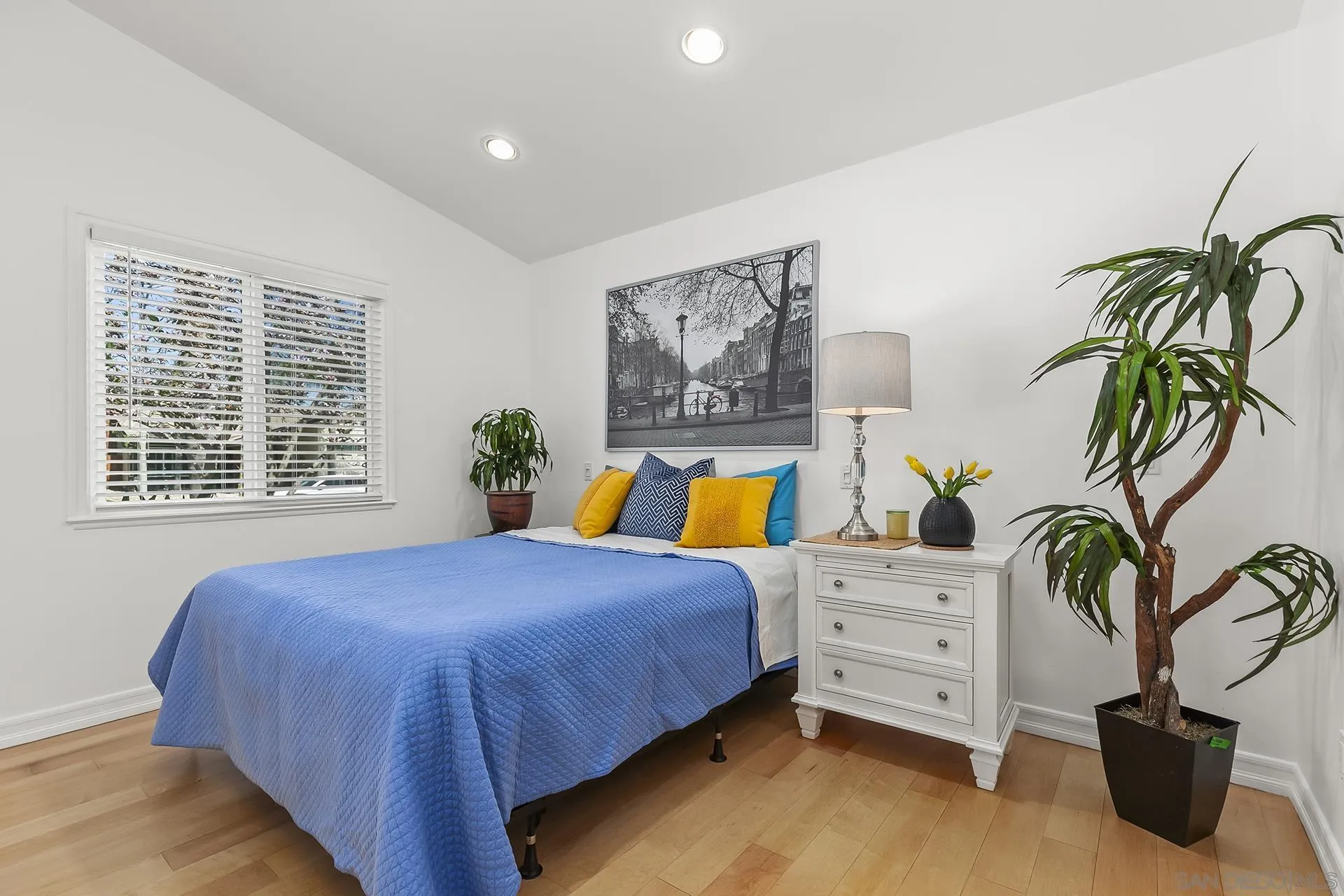 10371 Strathmore Drive Santee, CA 92071 - Photo 36 of 58 a bedroom with a bed and a potted plant