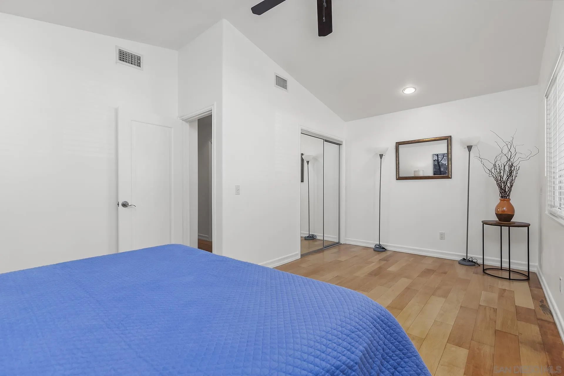 10371 Strathmore Drive Santee, CA 92071 - Photo 37 of 58 a bedroom with a large bed and a chandelier