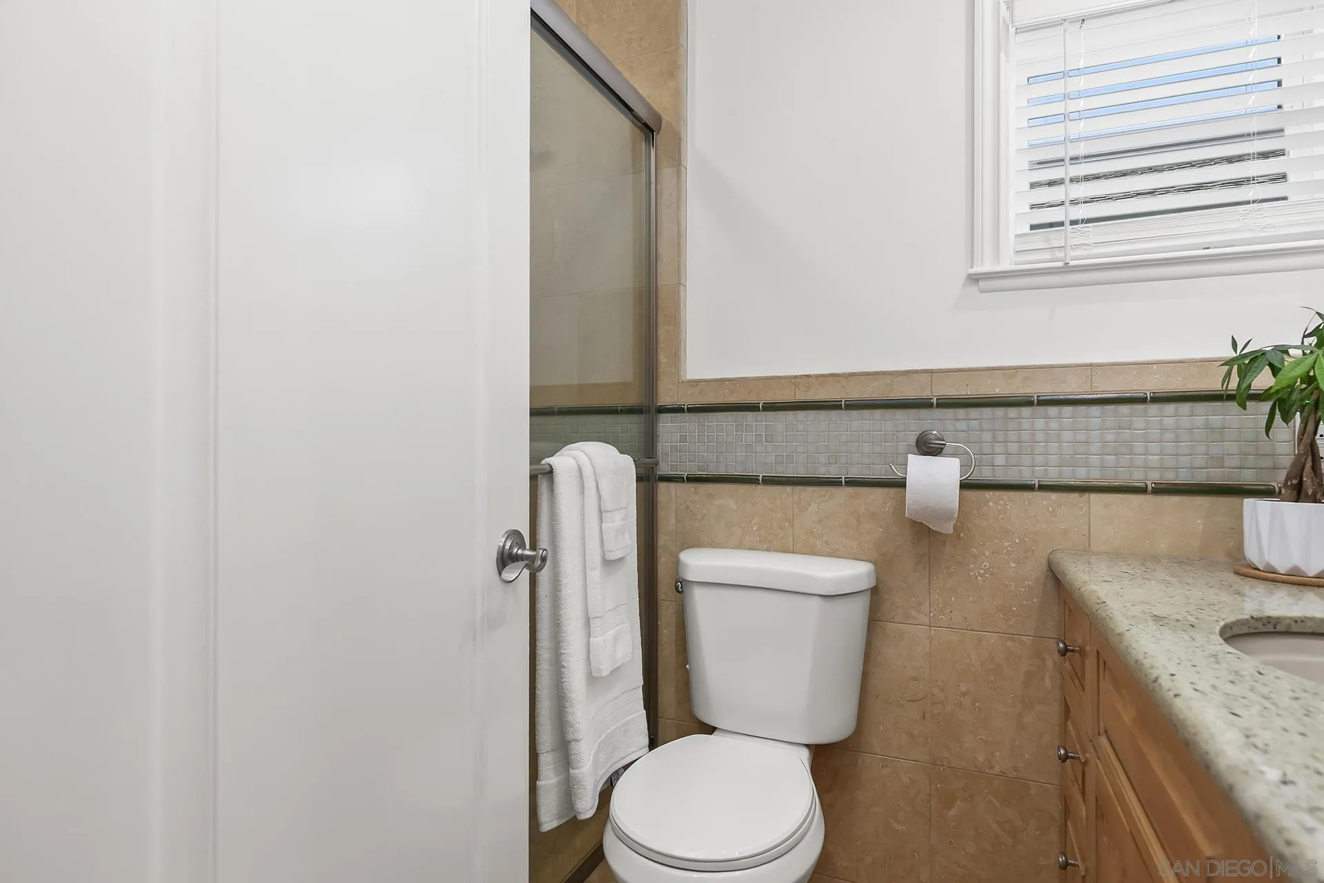 10371 Strathmore Drive Santee, CA 92071 - Photo 39 of 58 a white toilet sitting next to a bathroom sink