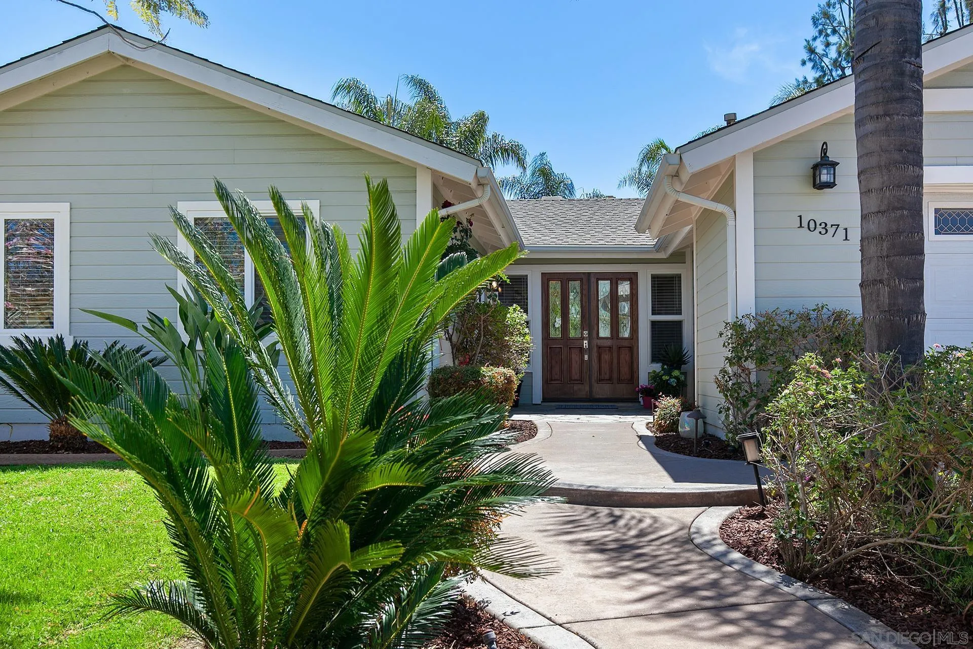 10371 Strathmore Drive Santee, CA 92071 - Photo 4 of 58 a front view of a house with garden