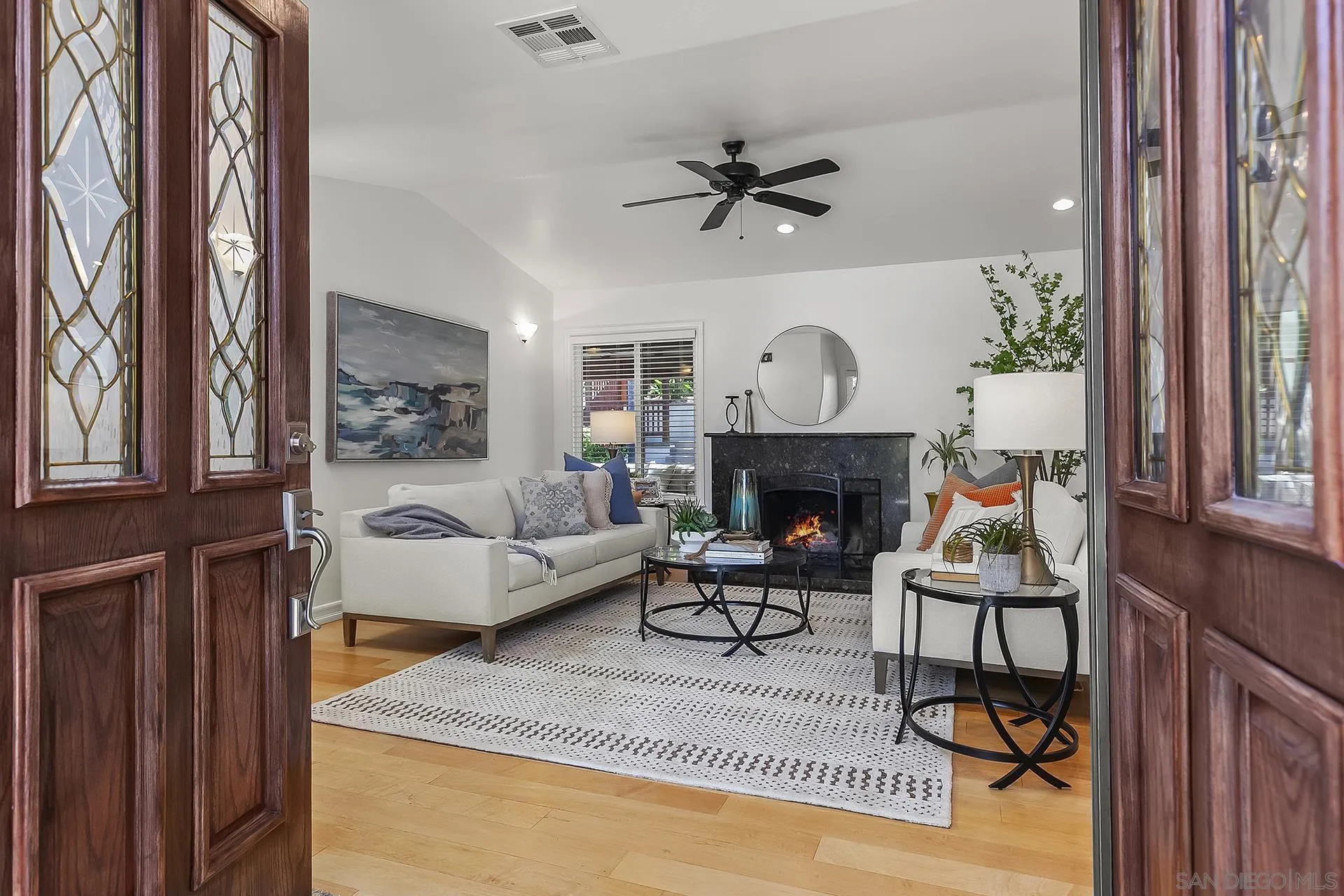 10371 Strathmore Drive Santee, CA 92071 - Photo 8 of 58 a living room with furniture a fireplace and a window