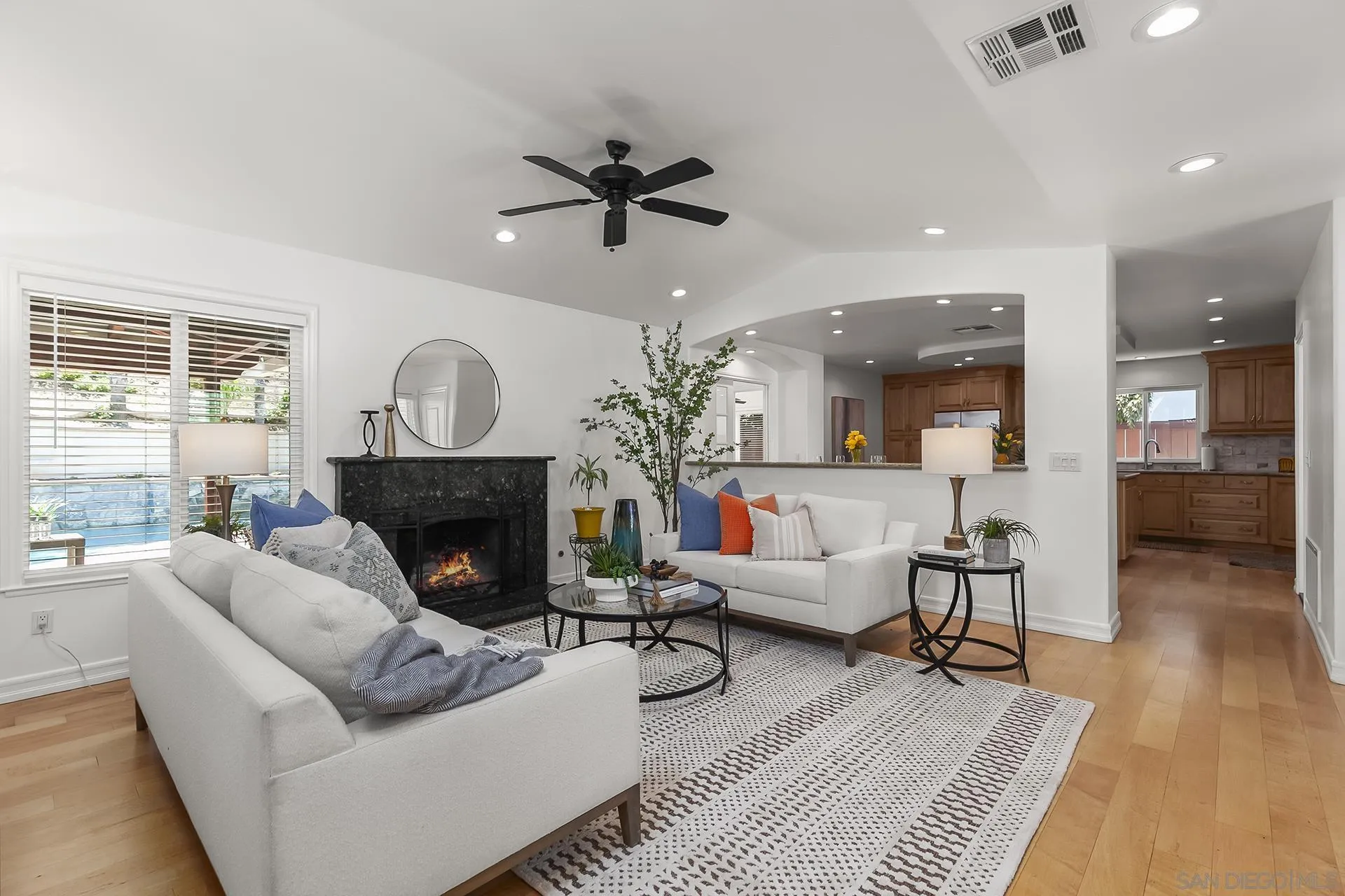 10371 Strathmore Drive Santee, CA 92071 - Photo 9 of 58 a living room with furniture a fireplace and a potted plant