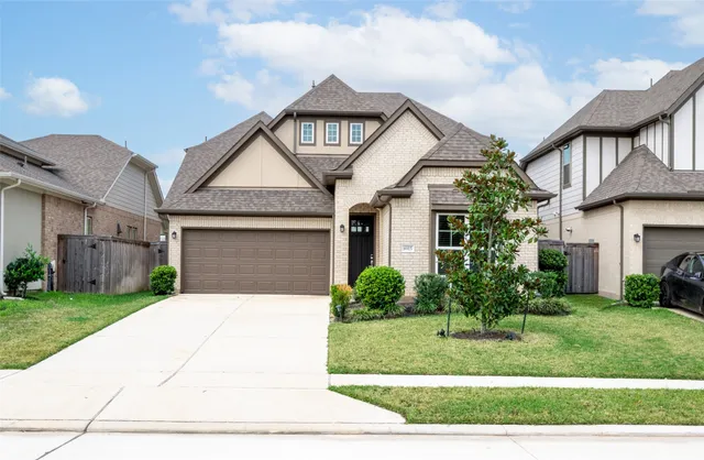 a front view of a house with a yard and garage
