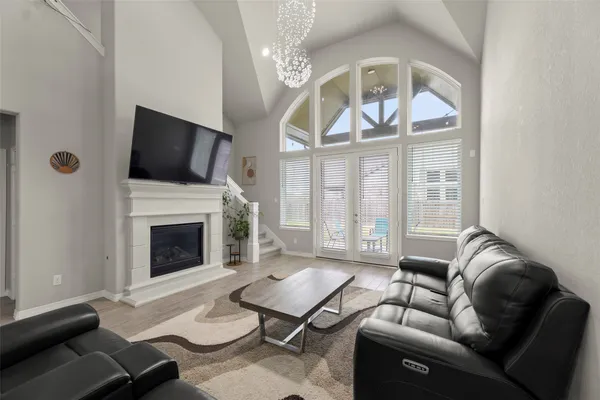 a living room with furniture a fireplace and a flat screen tv