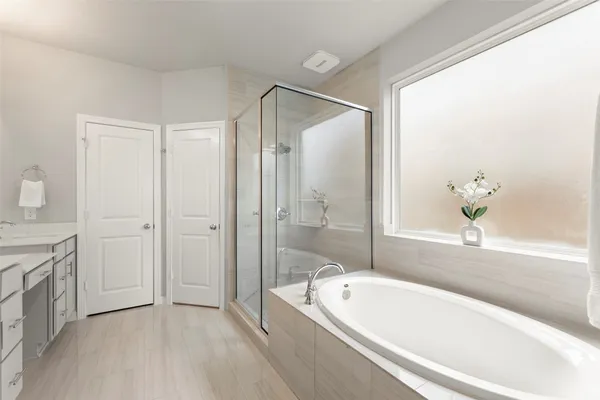 a spacious bathroom with a tub shower and sink