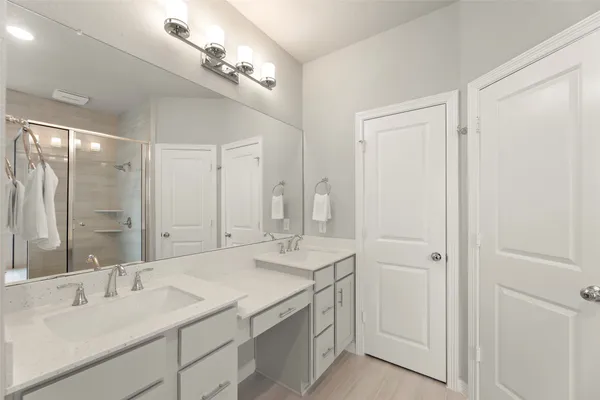 a bathroom with a double vanity sink and a mirror