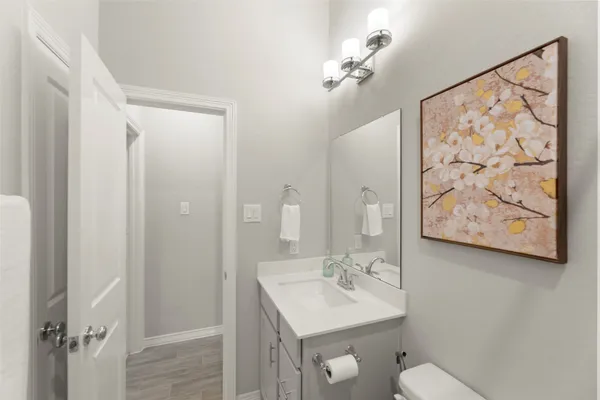 a bathroom with a toilet a sink and mirror