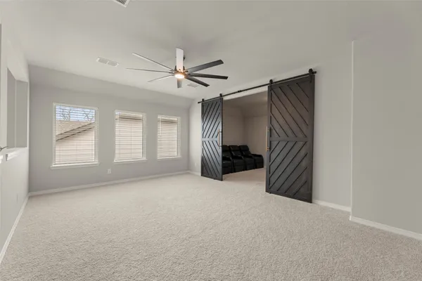 a view of empty room with fireplace and fan