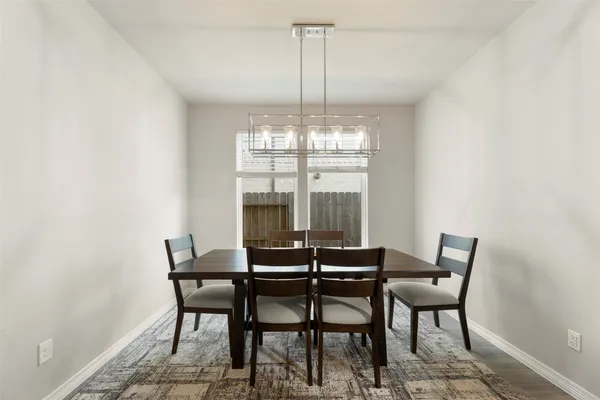 a view of a dining room with furniture and window