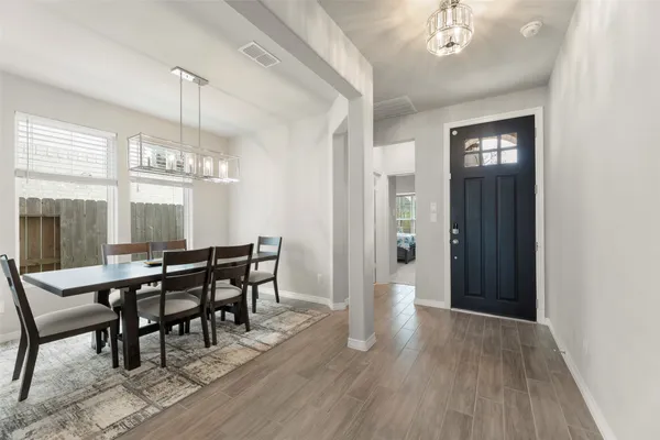 a view of a dining room with furniture window and wooden floor