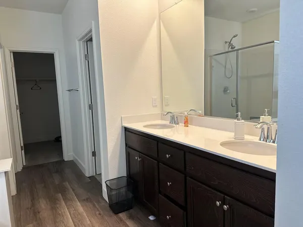 a bathroom with a double vanity sink and mirror