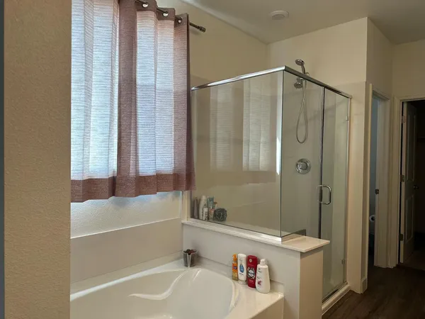 a bathroom with a tub a sink and a shower