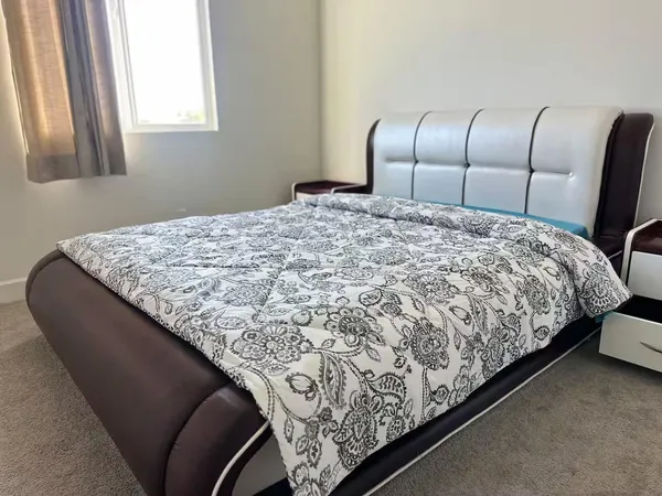 a bed sitting in a bedroom next to a window