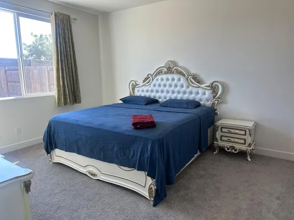 a bedroom with a bed and a window