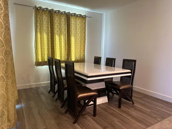 a view of a dining room with furniture and window