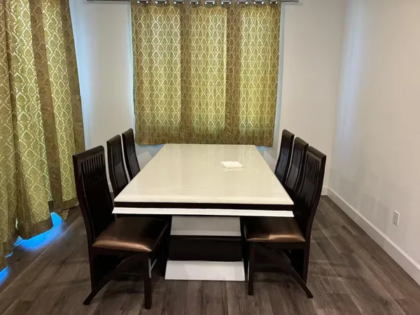 a view of a dining room with furniture and wooden floor