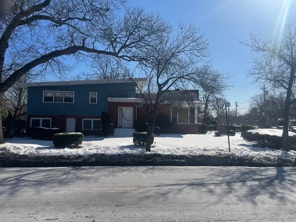 a view of a house with a snow on the road