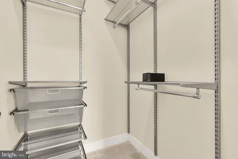 a view of closet with wooden floor