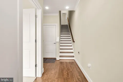 a view of a hallway with wooden floor