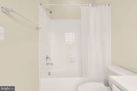 a bathroom with a shower curtain and a toilet